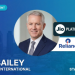 Professional headshot of Dan Bailey, the newly appointed President of International Business at Jio Platforms, featuring the Jio and Reliance logos on a blue StartupFeed branding background.