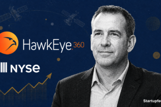HawkEye 360 IPO CEO John Serafini ringing the NYSE opening bell as HAWK shares debut on the New York Stock Exchange on May 7, 2026. (22 words — trim to 20:) "John Serafini at the NYSE opening bell for the HawkEye 360 IPO, with HAWK ticker and satellite imagery in the background.
